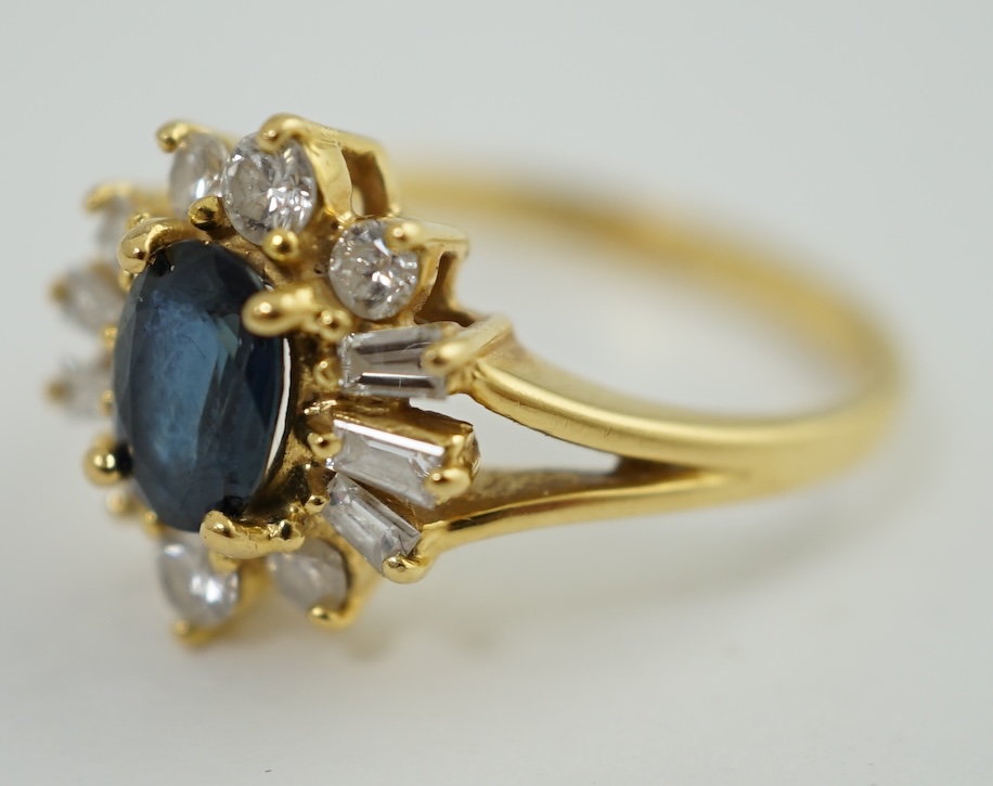 A modern 18ct gold, sapphire and diamond oval cluster ring